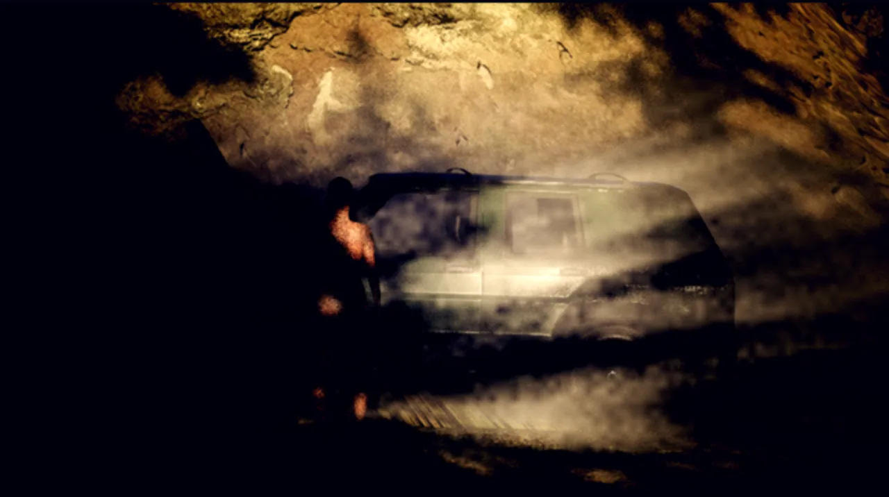 Headlights in the fog under a rock face